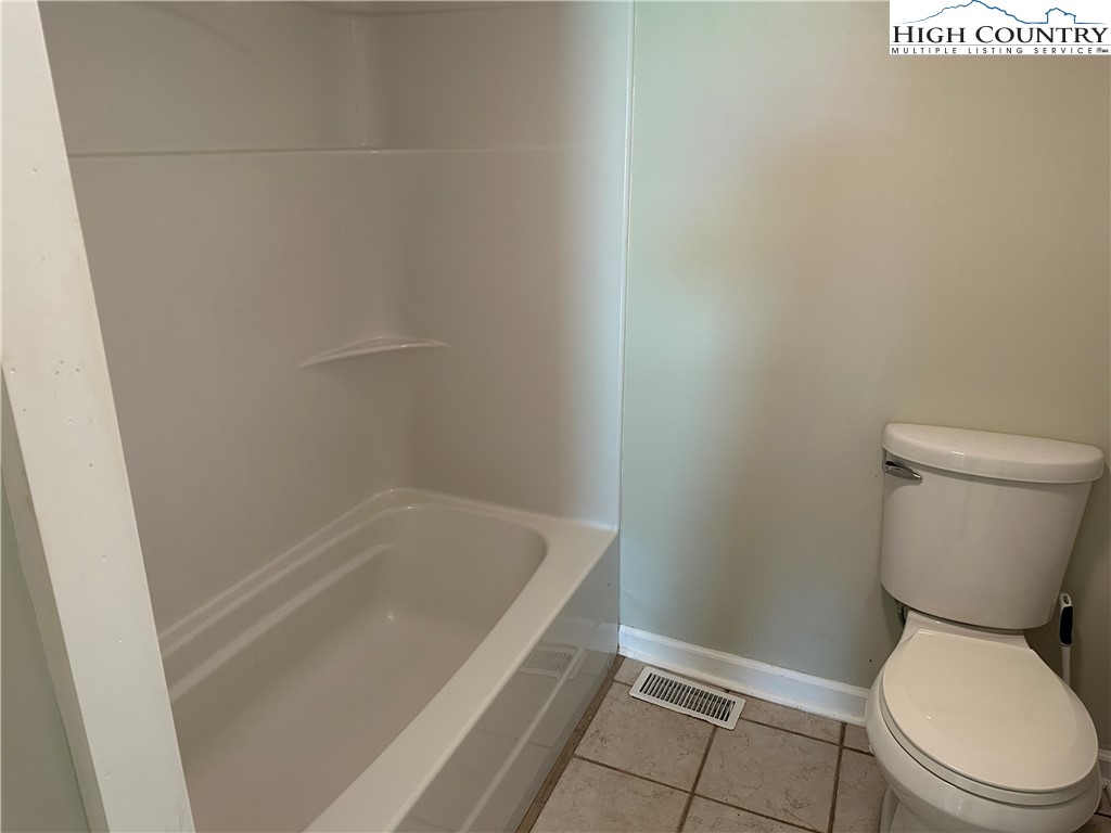 405 Wilson Road Ennice, NC 28623 - Photo 13 of 29 a white toilet sitting next to a sink