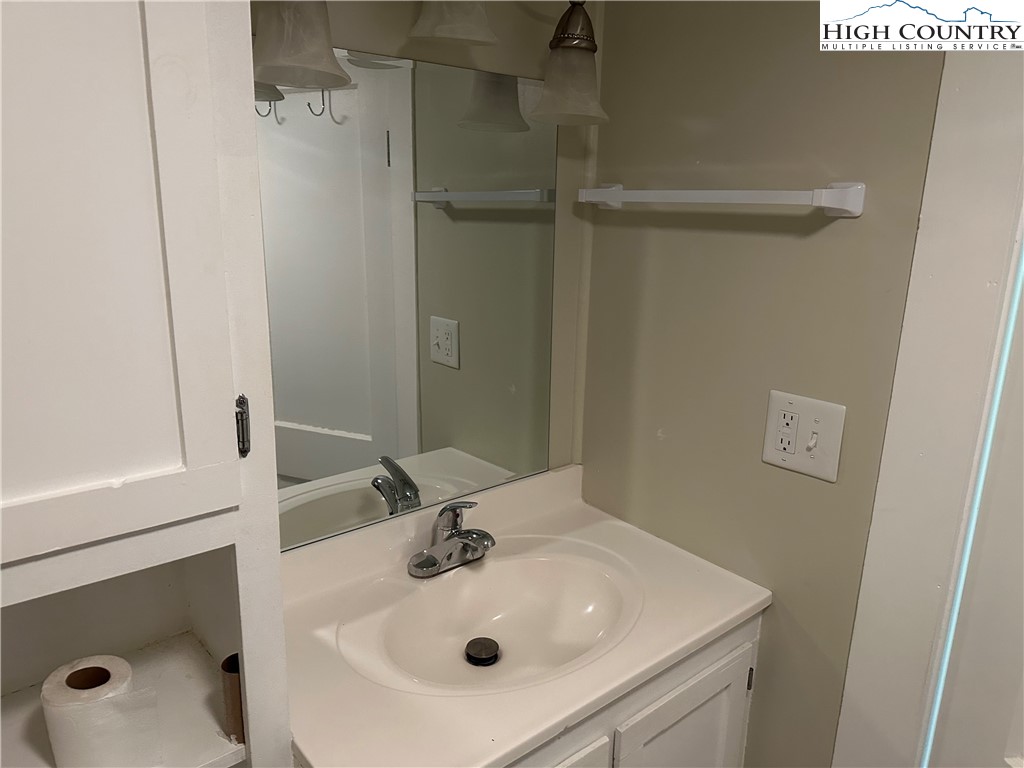 405 Wilson Road Ennice, NC 28623 - Photo 15 of 29 a bathroom with a sink and mirror