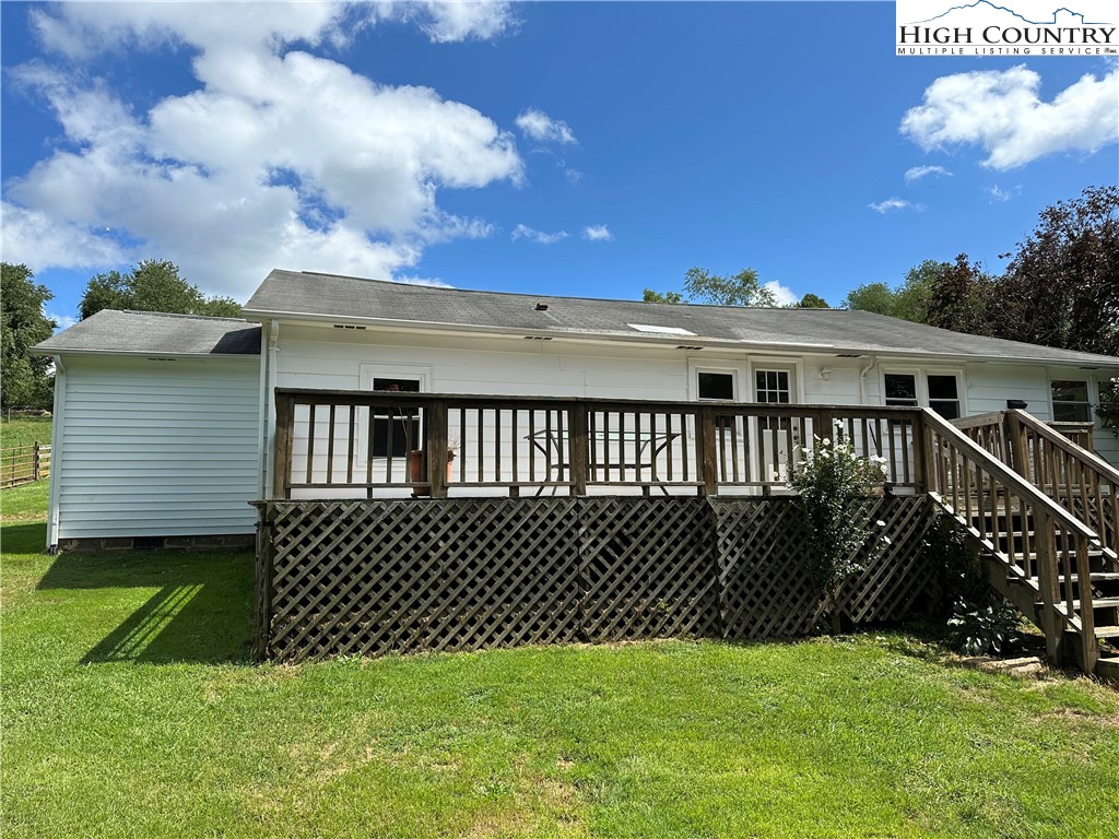 405 Wilson Road Ennice, NC 28623 - Photo 16 of 29 a view of a house with a backyard