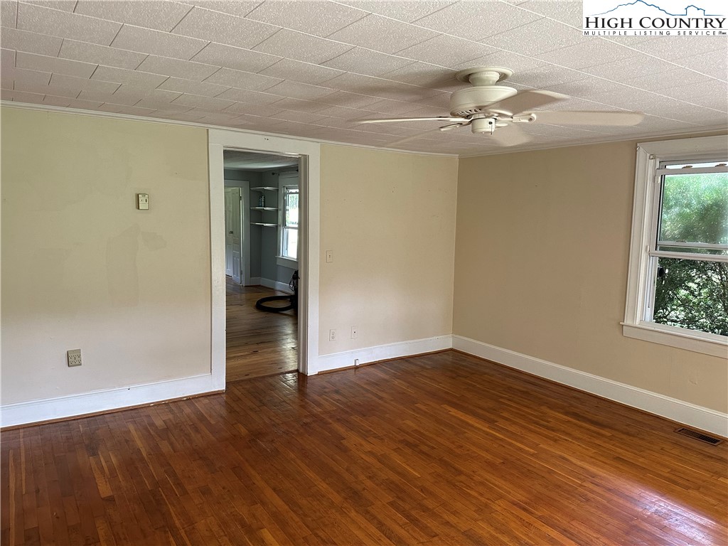 405 Wilson Road Ennice, NC 28623 - Photo 6 of 29 wooden floor in an empty room with a window
