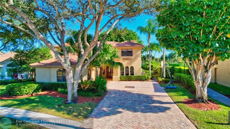 Mission Bay Boca Raton, FL 33428 - Photo 2 of 33 a front view of a house with a yard and trees