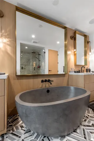 a spacious bathroom with a bathtub and mirror