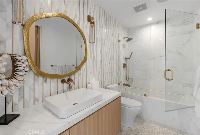 a bathroom with a toilet a sink and a mirror