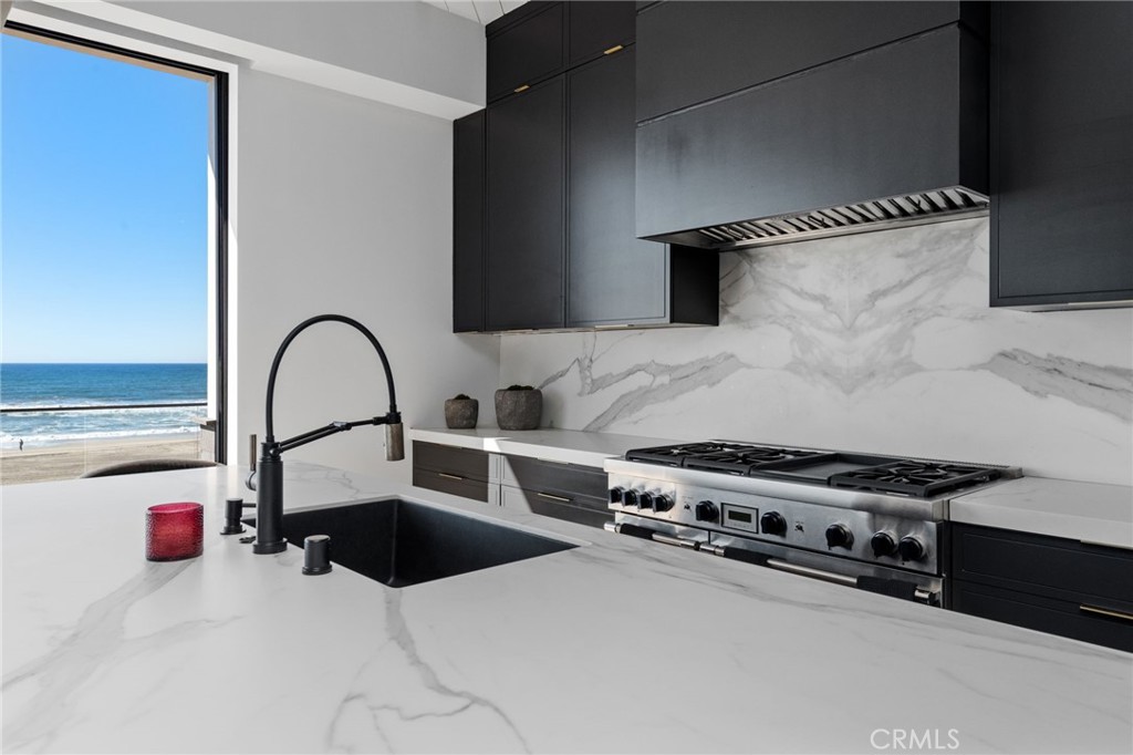 2200 The Strand, Unit A Manhattan Beach, CA 90266 - Photo 34 of 38 a kitchen with stainless steel appliances kitchen island a stove and a sink