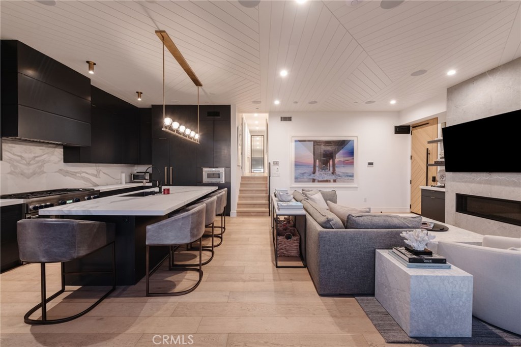 2200 The Strand, Unit A Manhattan Beach, CA 90266 - Photo 7 of 38 a living room with fireplace furniture and a flat screen tv