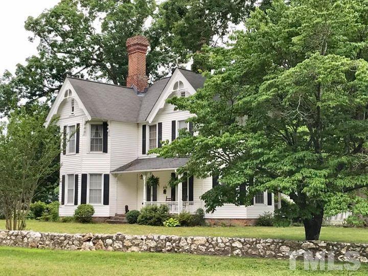 2685 Ridgeville Road Prospect Hill, NC 27314 - Photo 1 of 25 a front view of a house with a garden and plants