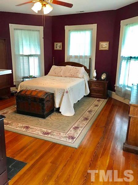 2685 Ridgeville Road Prospect Hill, NC 27314 - Photo 14 of 25 a spacious bedroom with a bed and a window