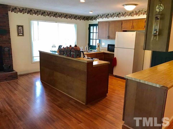 2685 Ridgeville Road Prospect Hill, NC 27314 - Photo 18 of 25 a living room with stainless steel appliances granite countertop a refrigerator and a wooden floors
