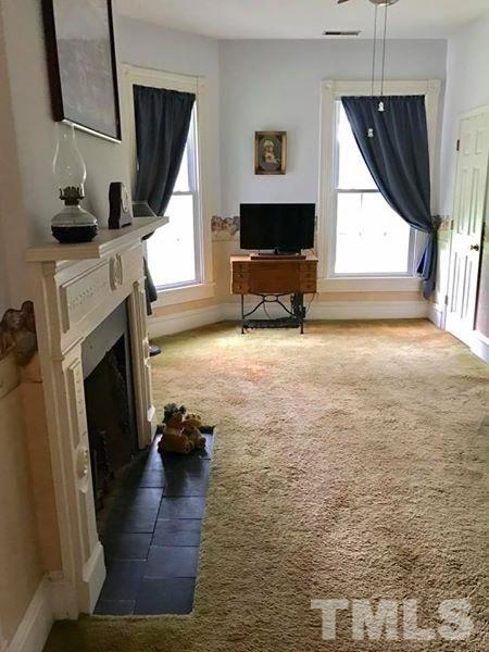 2685 Ridgeville Road Prospect Hill, NC 27314 - Photo 23 of 25 a living room with furniture and a fireplace