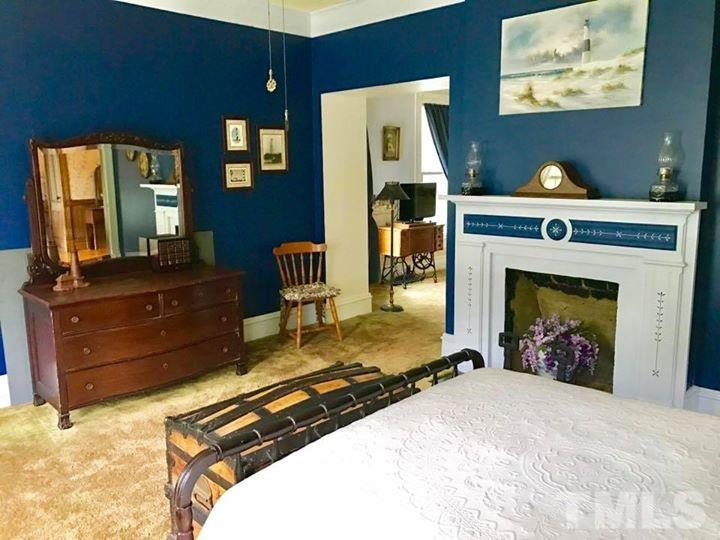 2685 Ridgeville Road Prospect Hill, NC 27314 - Photo 9 of 25 a bed room with a bed and a fireplace