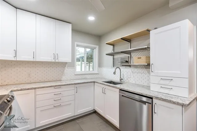 a kitchen with a sink stove and cabinets