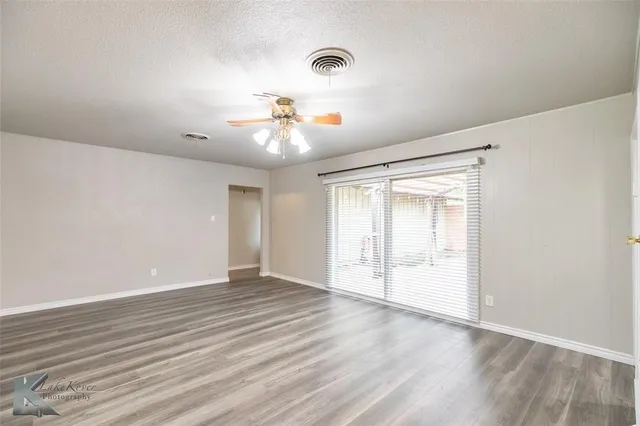 a kitchen with cabinets appliances a sink and a window