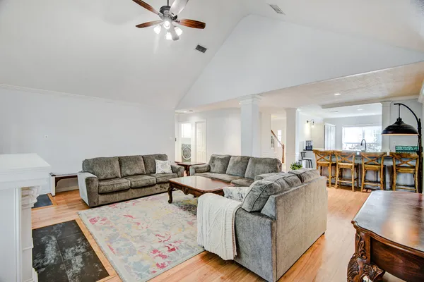 a living room with furniture and a chandelier
