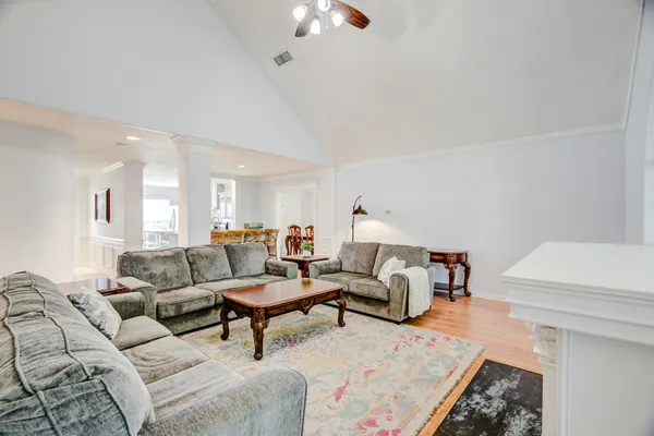 a living room with furniture fireplace and a large window