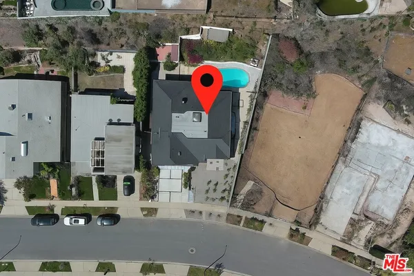 an aerial view of residential house with outdoor space and parking
