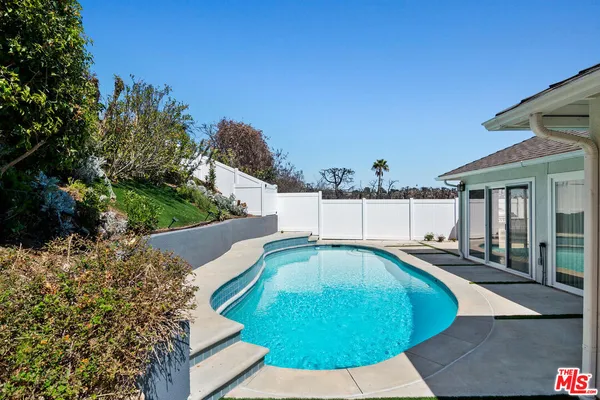 a view of a swimming pool with a patio