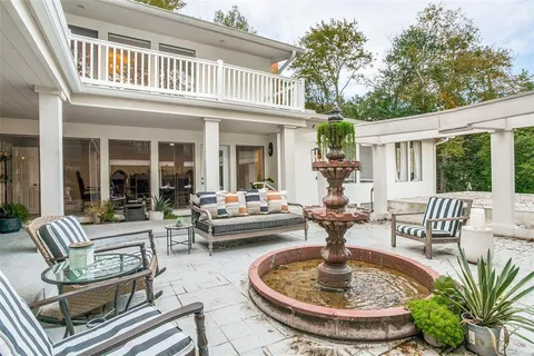 a view of a house with swimming pool and furniture