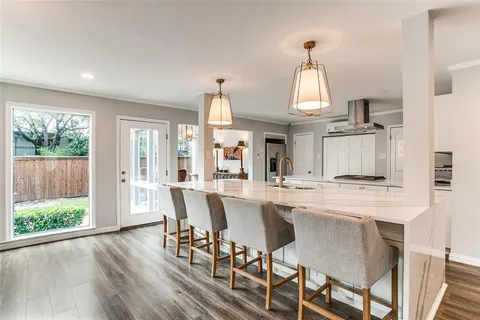 a dining room with furniture window and wooden floor