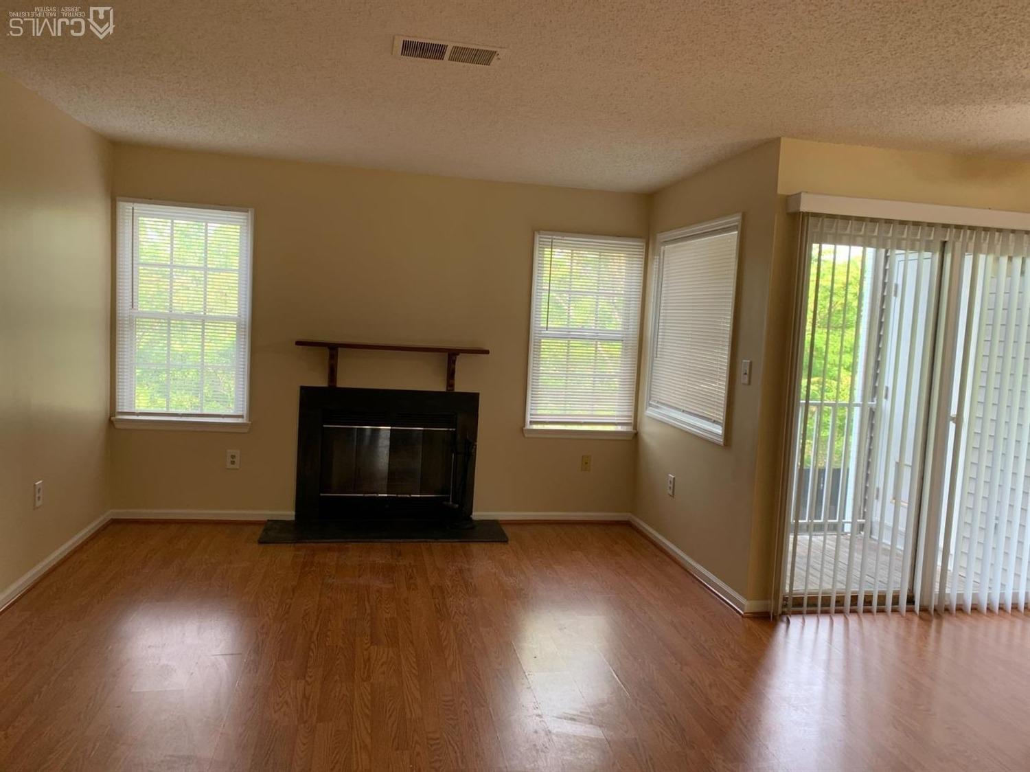 1226 Edpas Road New Brunswick, NJ 08901 - Photo 2 of 18 an empty room with wooden floor and windows