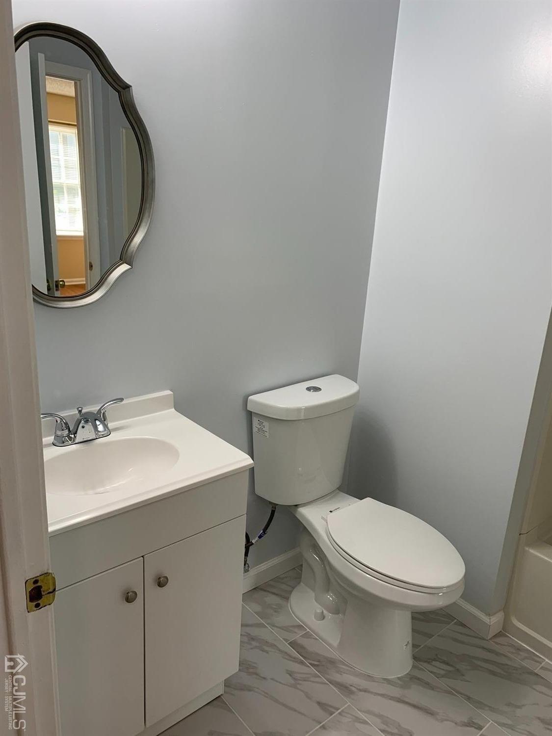 1226 Edpas Road New Brunswick, NJ 08901 - Photo 13 of 18 a white toilet sitting next to a bathroom sink