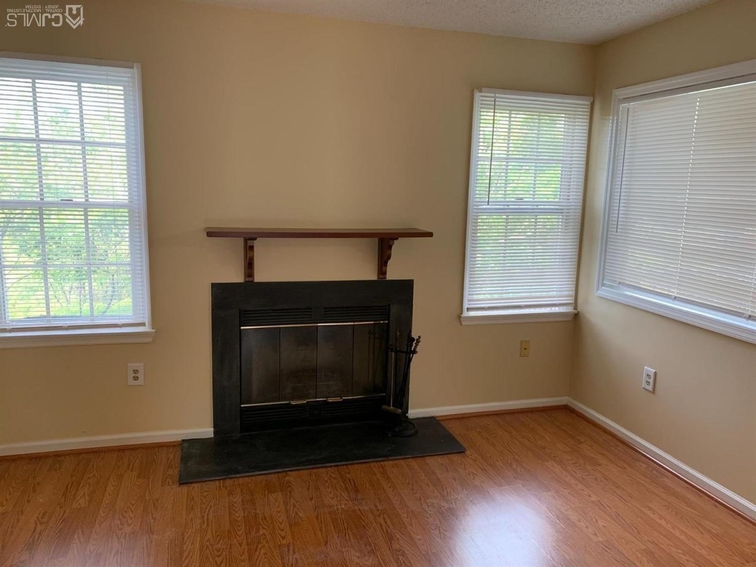 1226 Edpas Road New Brunswick, NJ 08901 - Photo 14 of 18 a living room with a fireplace and windows