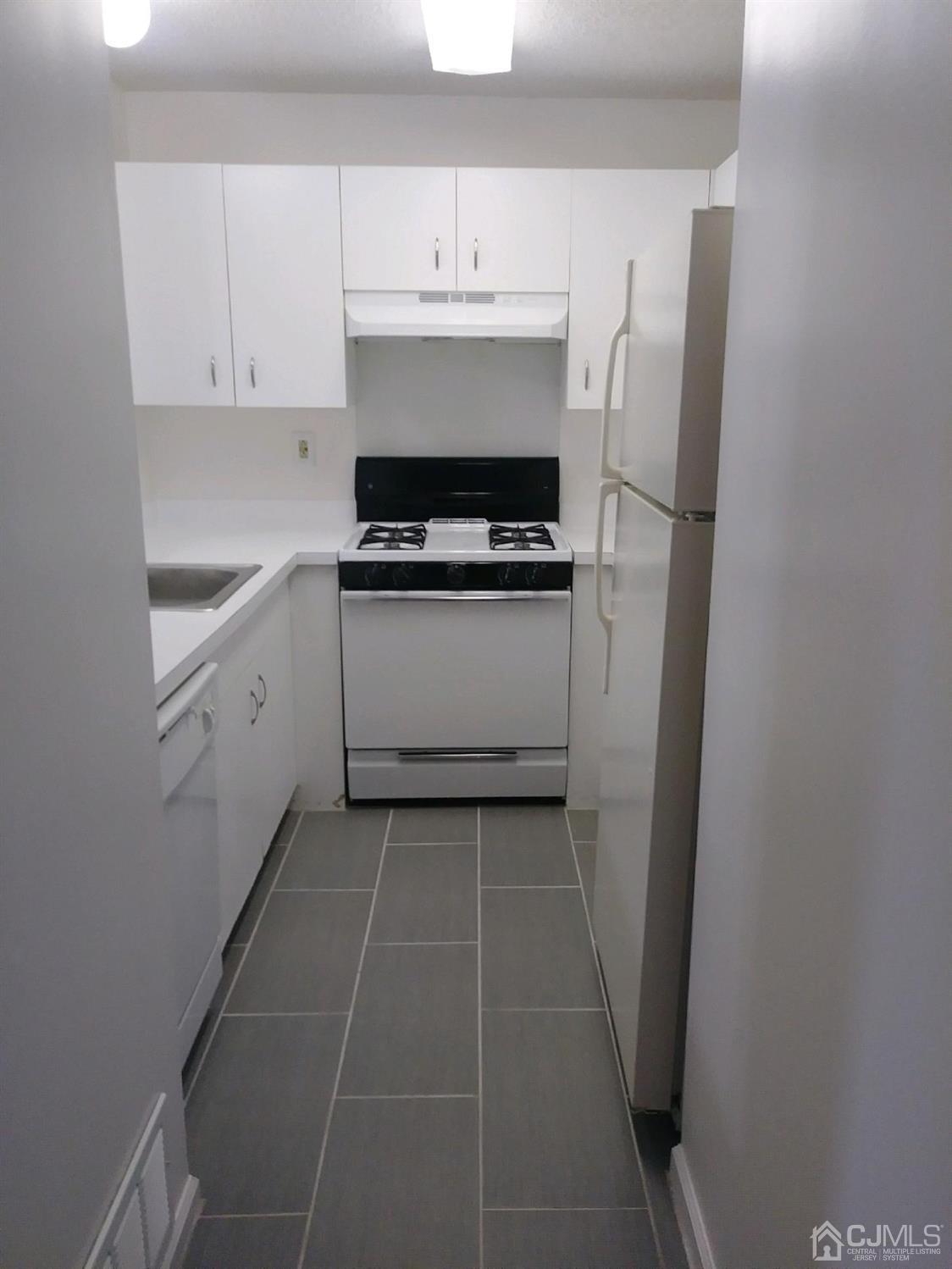 1226 Edpas Road New Brunswick, NJ 08901 - Photo 15 of 18 a utility room with cabinets washer and dryer