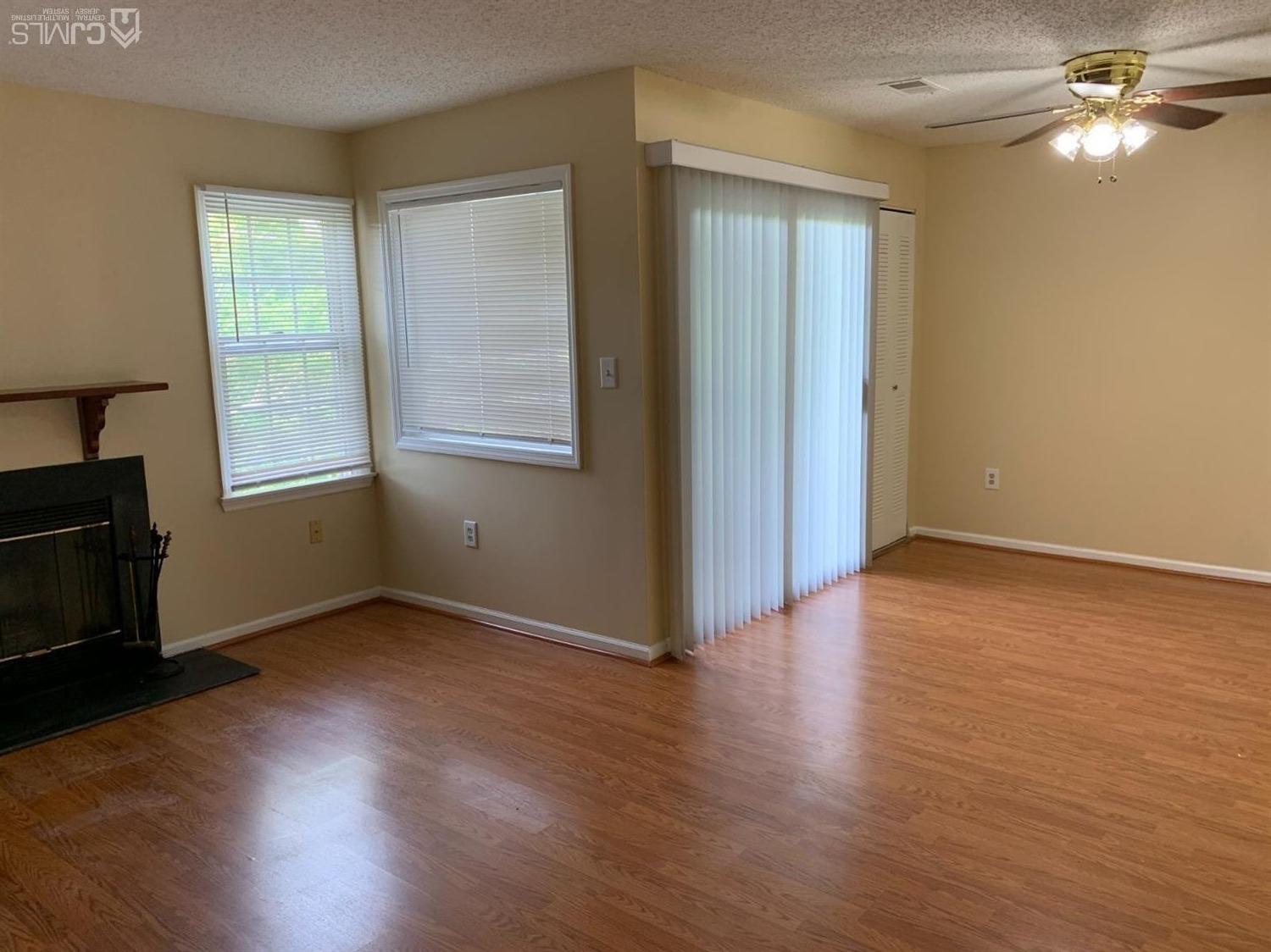 1226 Edpas Road New Brunswick, NJ 08901 - Photo 4 of 18 an empty room with wooden floor cabinet and windows