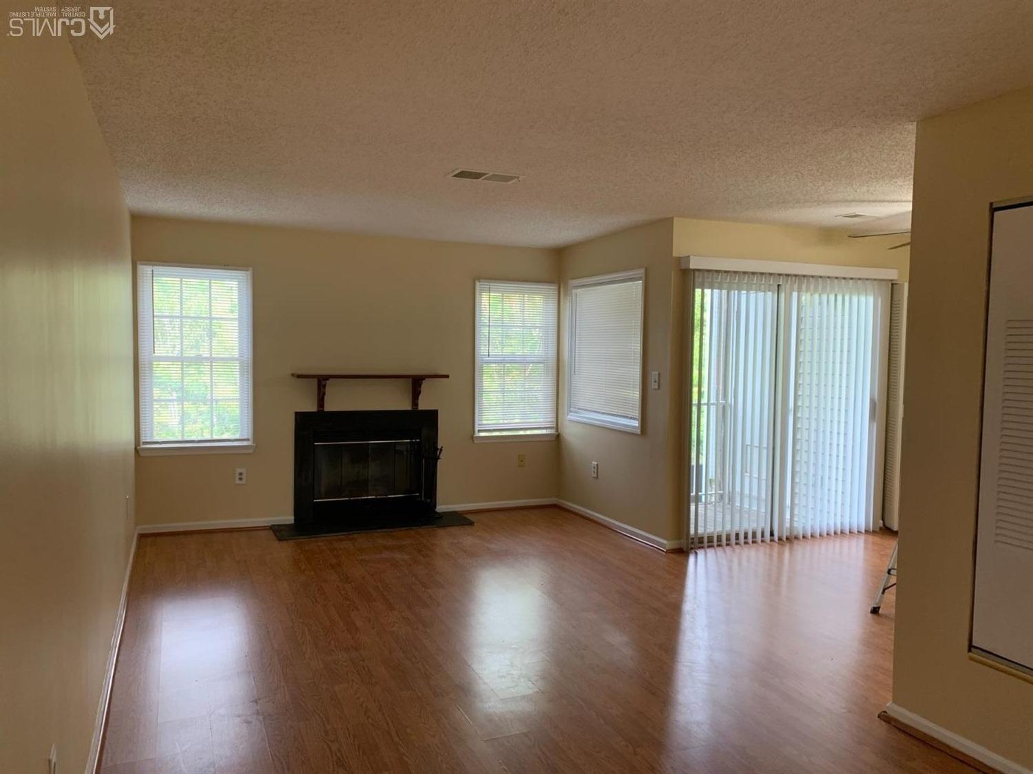 1226 Edpas Road New Brunswick, NJ 08901 - Photo 5 of 18 an empty room with windows and a fireplace