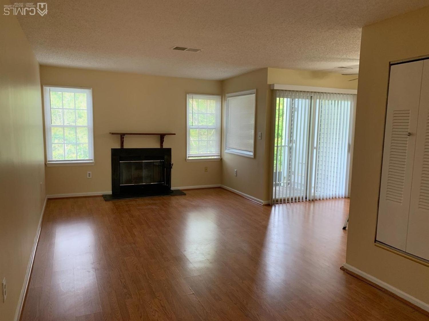 1226 Edpas Road New Brunswick, NJ 08901 - Photo 7 of 18 an empty room with wooden floor and windows