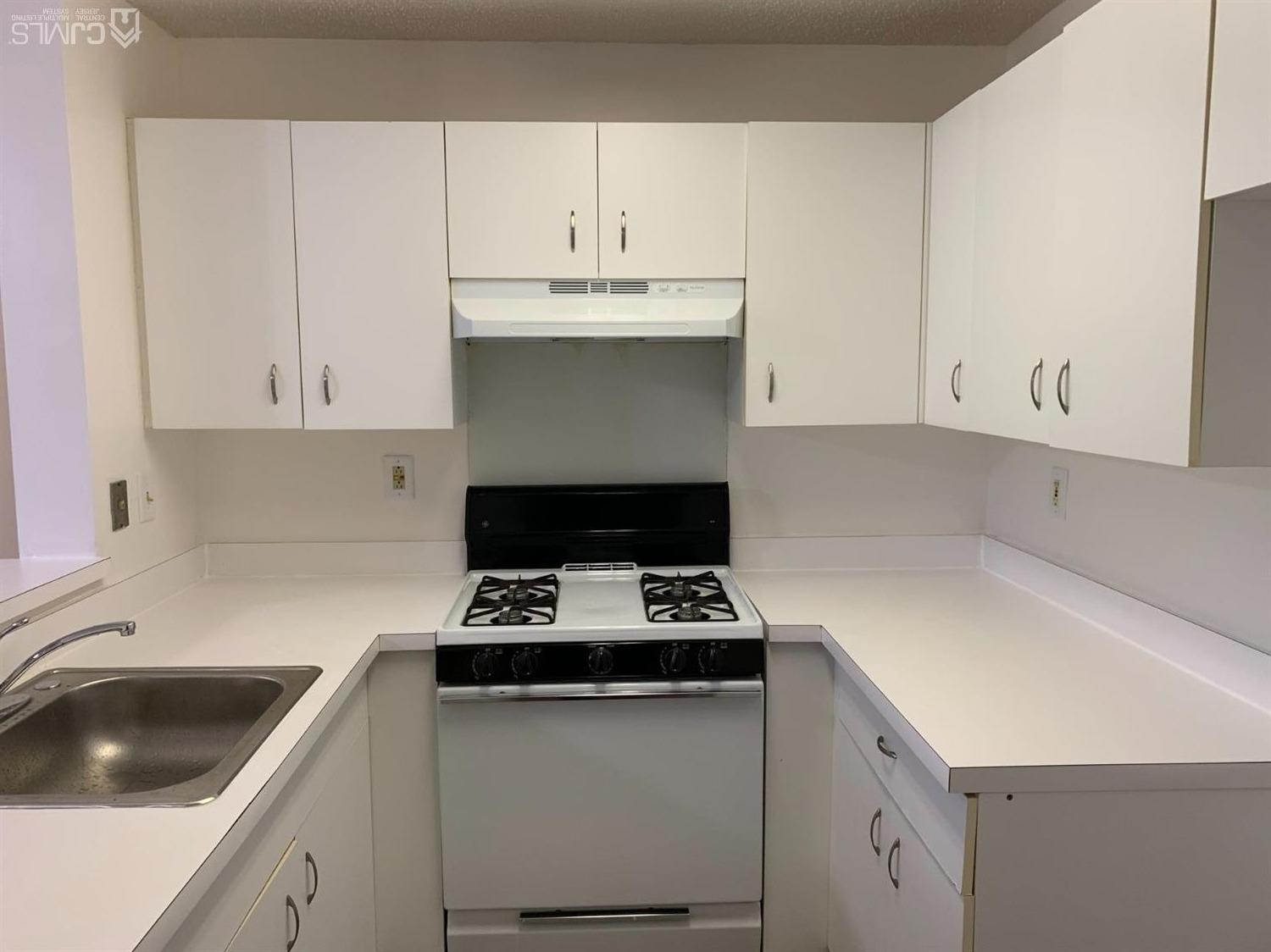 1226 Edpas Road New Brunswick, NJ 08901 - Photo 8 of 18 a kitchen with cabinets and white appliances