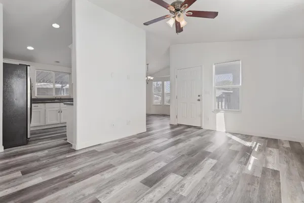 a view of a livingroom with a hall and wooden floor