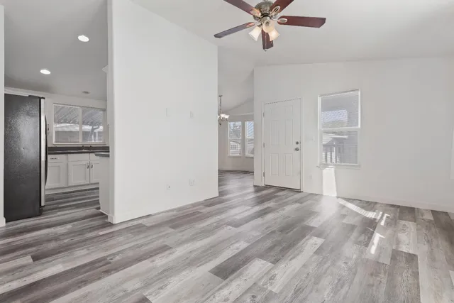 a view of a livingroom with a hall and wooden floor