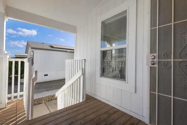 a view of a hallway with wooden floor and entryway
