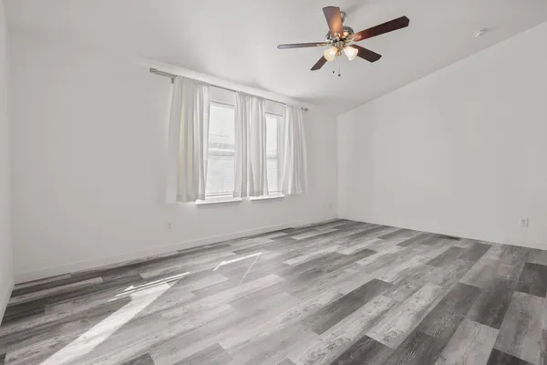 a view of empty room with ceiling fan