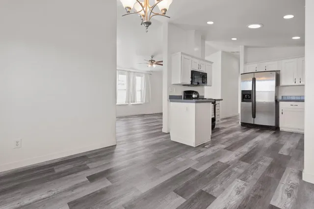 a kitchen with a refrigerator and a stove top oven