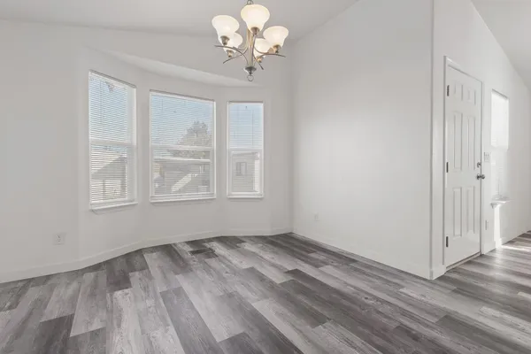 a view of wooden floor and windows in a room