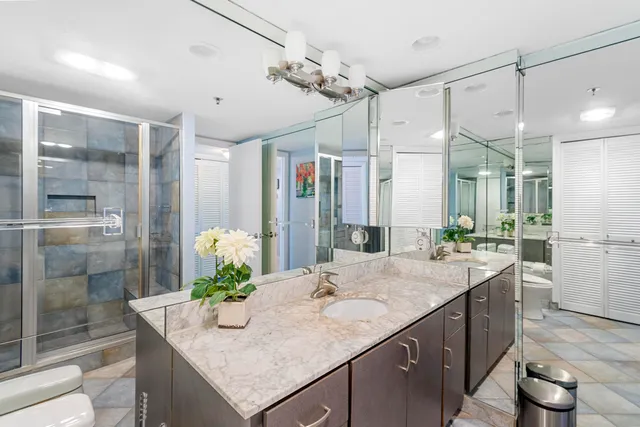 a dining room with stainless steel appliances kitchen island granite countertop a table and chairs in it