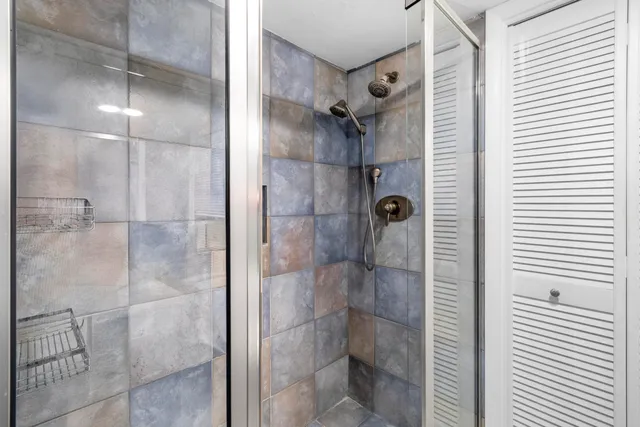 a bedroom with a large bed and a potted plant