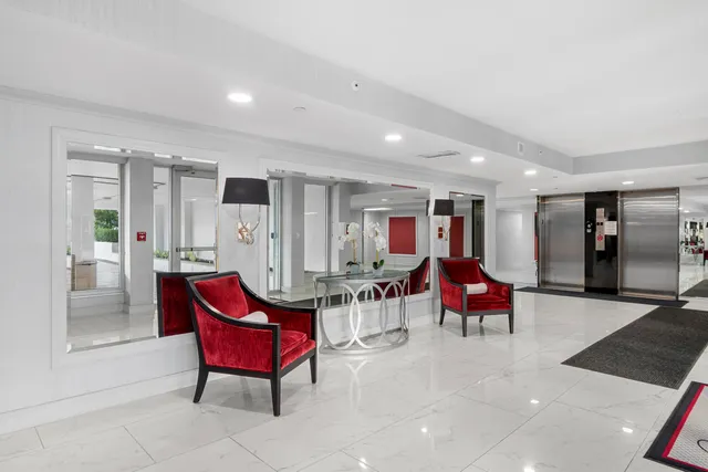 a view of a room with chairs and wooden floor