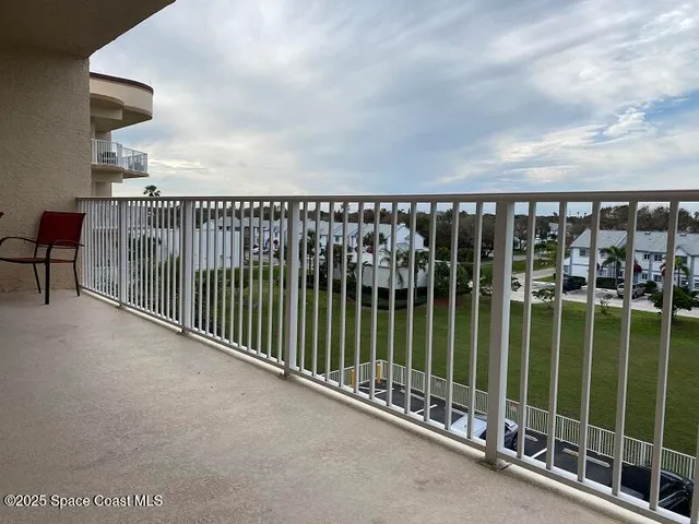 a view of a balcony with wooden floor