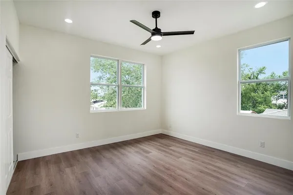 a view of a room with wooden floor and a window