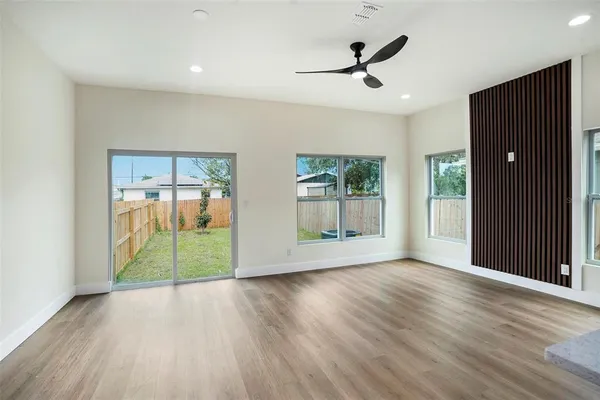 wooden floor in an empty room with a window