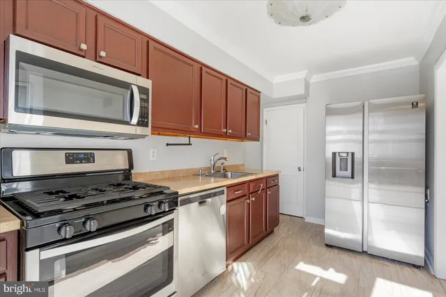 a kitchen with stainless steel appliances granite countertop a stove and a microwave