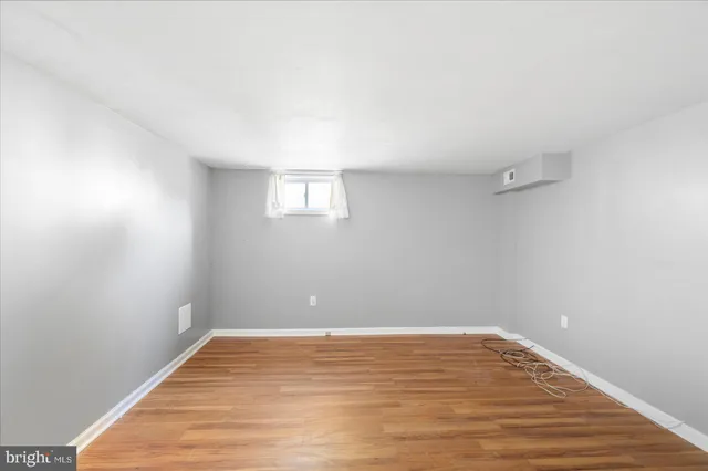 a view of a room with wooden floor and white walls