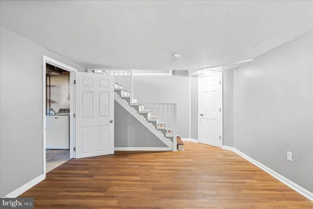 a view of a room with wooden floor and staircase