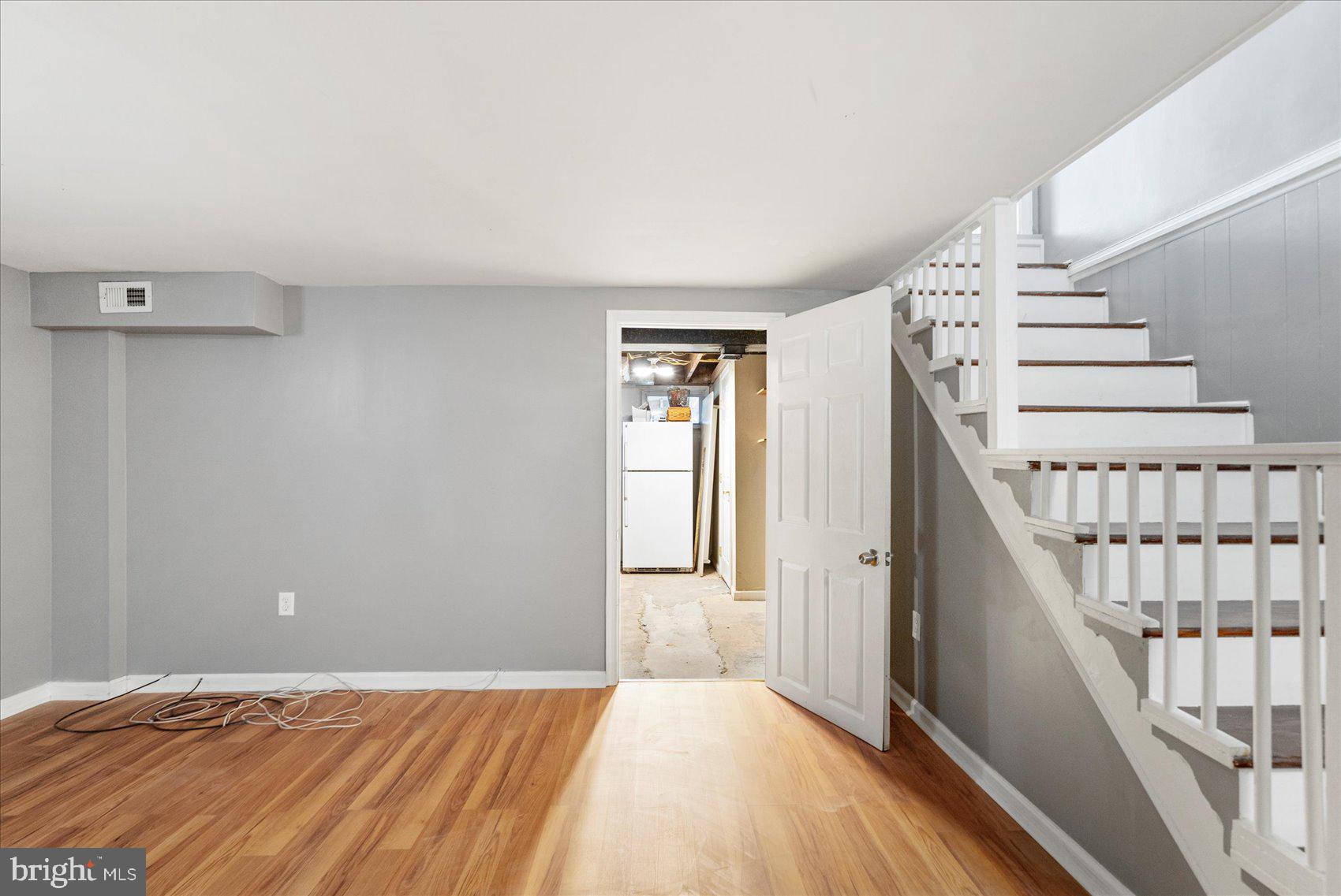 11 Cardinal Road Baltimore, MD 21221 - Photo 15 of 37 a view of an empty room with wooden floor and stairs