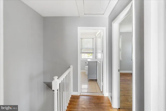 a view of a hallway with wooden floor and entryway