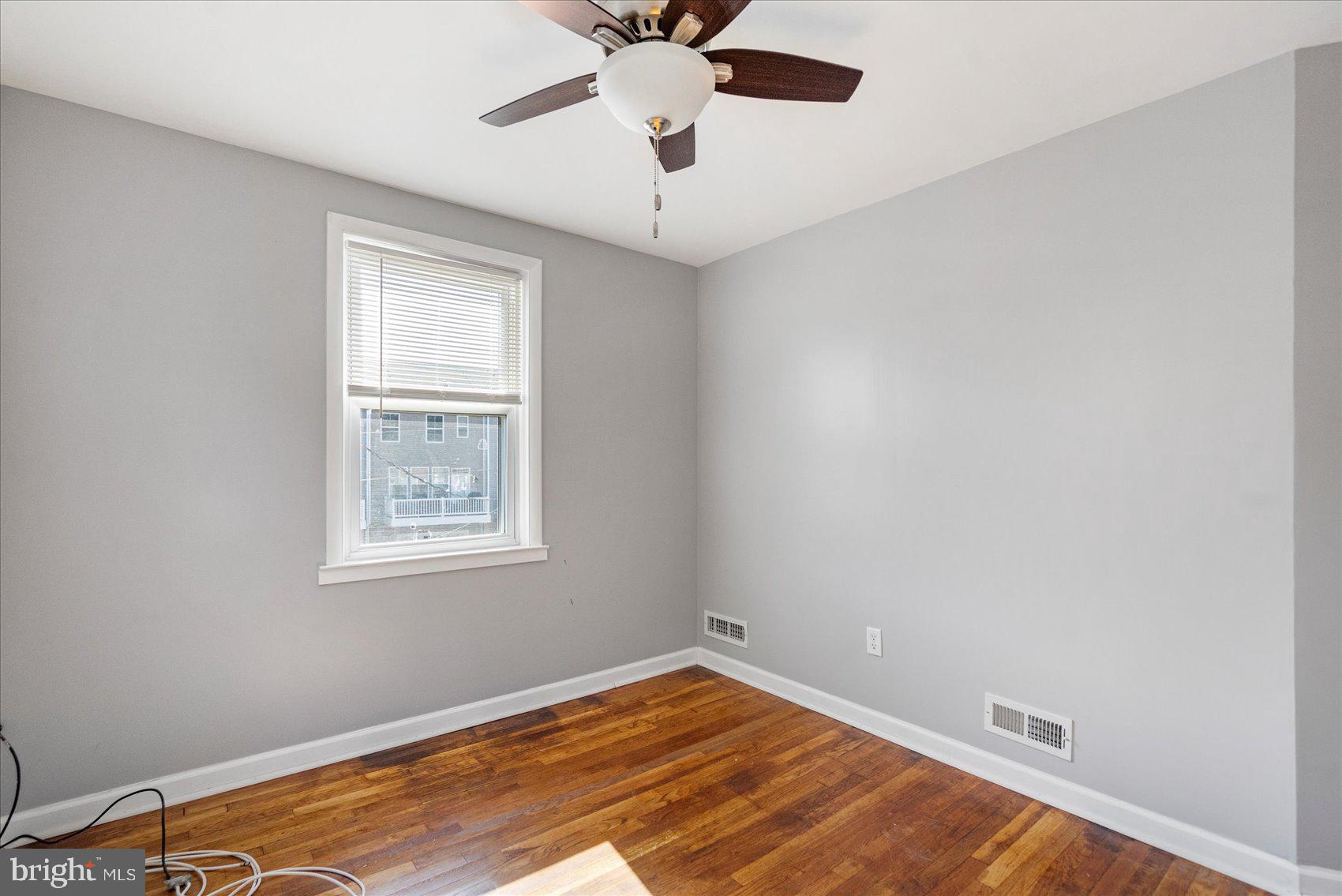 11 Cardinal Road Baltimore, MD 21221 - Photo 23 of 37 a view of an empty room with window and a chandelier fan