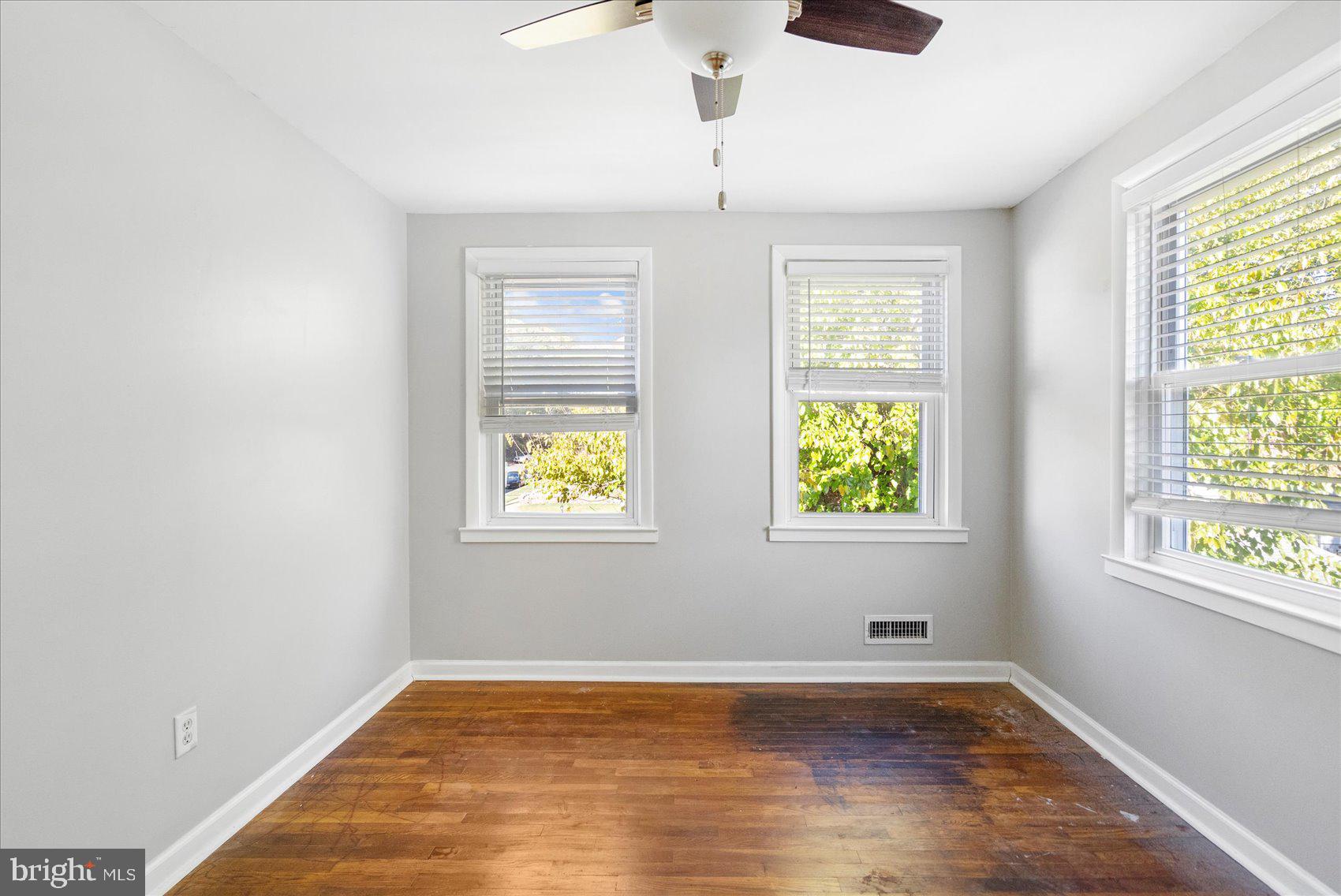 11 Cardinal Road Baltimore, MD 21221 - Photo 26 of 37 a view of an empty room with wooden floor and a window