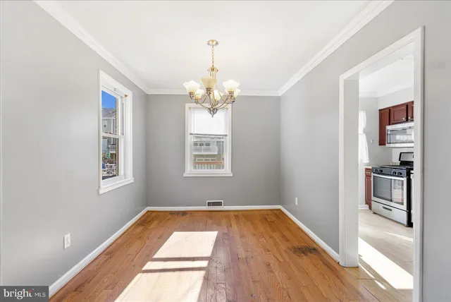 a view of a room with wooden floor and windows